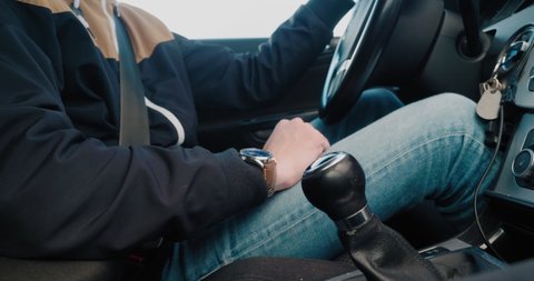 Simrishamn , Skåne , Sweden - 10 21 2021: Tall Man Driving and Rests His Hand on The Gear Stick Before Shifting Gears