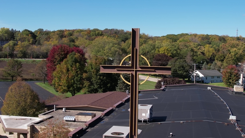 Aerial View of Cross on Modern Catholic Church in Residential Neighborhood on Sunny Autumn Day