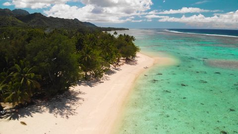 Aerail footage of Aroa Beach in the Rarotonga in the Cooks island in the southern Pacific. Shot with a backward motion
