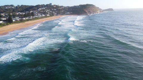 Aerial drone landscape view of waves ocean beach Summer in Avoca cliffside Central Coast tourism NSW Australia 4K