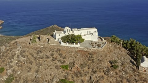 Paros Greece Aerial v9 orbit shot drone fly around monastery of agios antonios perched atop of rocky hill, church with stunning panoramic view of paros seaside and landscape - September 2021
