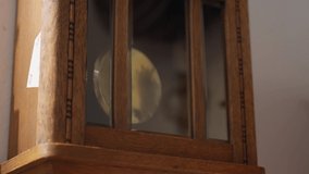 Push in shot of wall clock pendulum - Powered by Shutterstock - Get 15% off with code: PIKWIZARD15