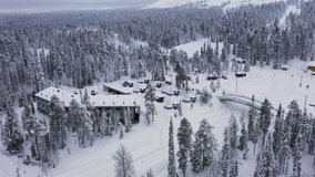 Aerial view towards snow covered aurora glass igloos, cloudy day in Lapland - Powered by Shutterstock - Get 15% off with code: PIKWIZARD15