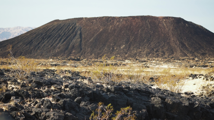 Amboy crater landscape switching focus to close up of volcanic rocks