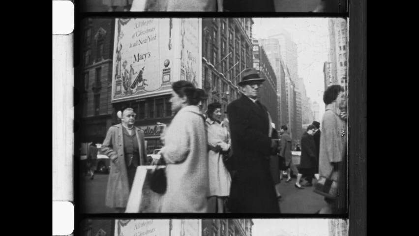 1950s New York City. Commuters cross a busy intersection below the Macy building in New York City, 4K Overscan of Vintage Archival 16mm Newsreel Film Footage. 