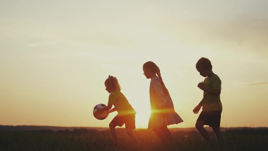 crowd of kids run. people in the park. happy family kid dream concept. brother sister little children holding a ball silhouette run across the field at sunset fun. happy family kids Royalty-Free Stock Footage #1087610561