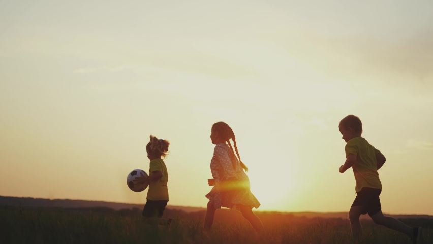 crowd of kids run. people in the park. happy family kid dream concept. brother sister little children holding a ball silhouette run across the field at sunset fun. happy family kids Royalty-Free Stock Footage #1087610561