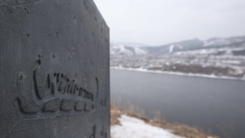 Beautiful river bank, mountains and a village on the other side of the river.