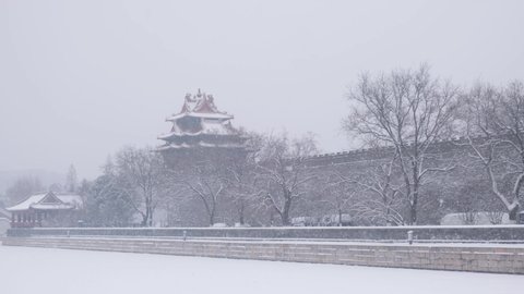 Corner tower of Forbidden City stands in heavy snow, Beijing, China.