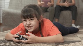 Girl with modern joystick. A family with child have free time with playstation game in the room.