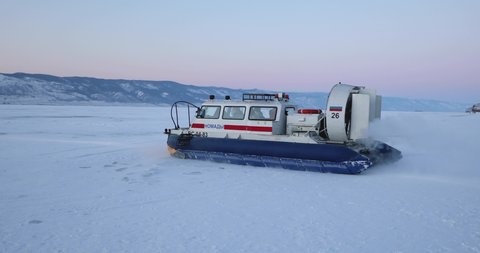 Hovercraft rides on Lake Baikal ice at sunset - Baikal Lake, Siberia