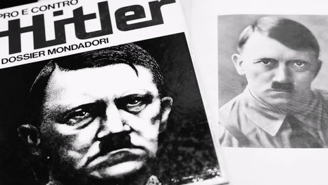 Rome, Italy - February 12, 2022, Rome, detail of the cover of the book Pro and Cons - Hitler and an image of Hitler in the book entitled My battle, Italian translation of Mein Kampf.