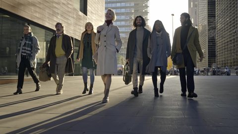 Business Team People walking together with confidence and determination towards their goal - Group of successful company professionals in the city