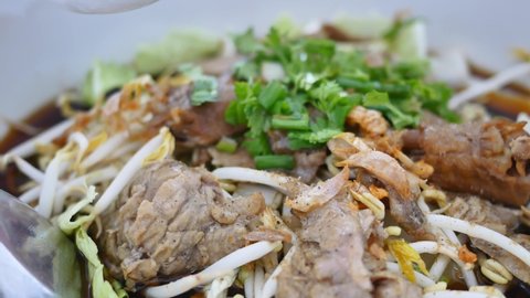 Duck noodles with soup in white bowl. Famous food in Thailand