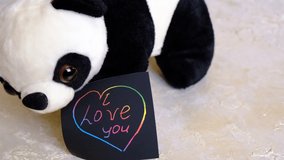 Note I love you for Valentines Day with cute panda toy. Art scratch paper for message - Powered by Shutterstock - Get 15% off with code: PIKWIZARD15