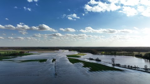 High water level in the river Vecht at the Junne weir in the Dutch Vechtdal region in Overijssel. The river is overflowing on the floodplains after heavy rainfall upstream after storm Eunice.