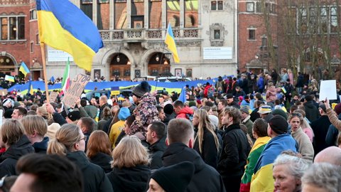 Crowd of people protesting against the Russian invasion of Ukraine: Anti war protests demonstration in Aarhus, Denmark on 26 February 2022. Showing people with Ukrainian flags.