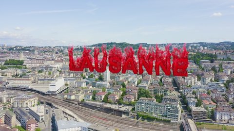 Inscription on video. Lausanne, Switzerland. Flight over the central part of the city. La Cite is a district historical centre. Flames with dark fire, Aerial View
