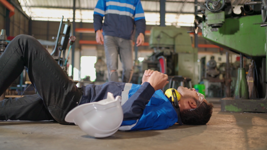 Man labor worker had accident on the floor at the production line of CNC machine factory. Engineer man walk to that area and support him on injured. Safety in industrial factory. Injury at work | Shutterstock HD Video #1087658951