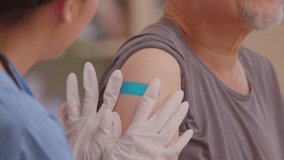 Close up bandage of Asian Elderly man after received anti virus vaccine cheerful and happiness.Hand of doctor with rubber gloves put bandage to elderly arm after vaccinate.vaccination Concept - Powered by Shutterstock - Get 15% off with code: PIKWIZARD15