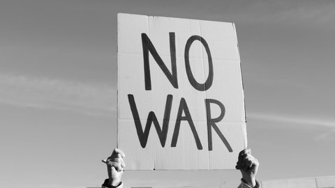 Stop war protest - People on street fighting for peace and human rights - Focus on banner sign - Black and white edition
