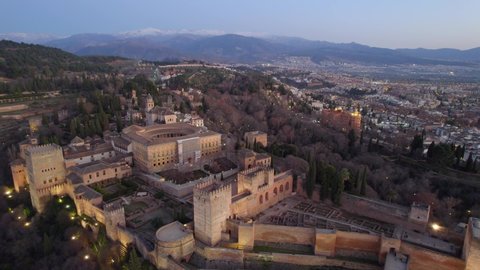 aerial view of Granada castle of Alhambra in the evening, famous Spanish landmark, moorish medieval historic monument in Spain, flying above fortress of Granada. High quality 4k footage