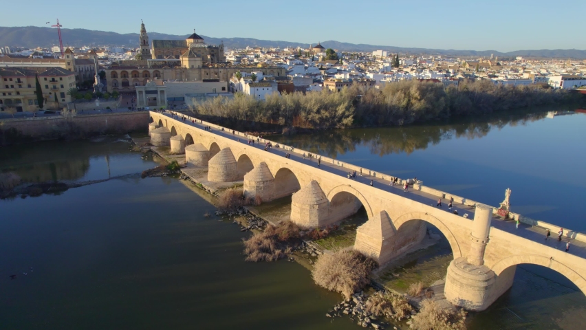 aerial view of the town of Cordoba in Andalusia, Spain, medieval cathedral and roman bridge over Guadalquivir river, UNESCO World Heritage site. High quality 4k footage