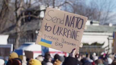 WARSAW, POLAND - FEBRUARY 27 2022: Demonstration, Protest Against The Russian War In Ukraine. Ukrainian Flag, Protesters, Send NATO Posters And Banners Visible On The Shot. People In The Street