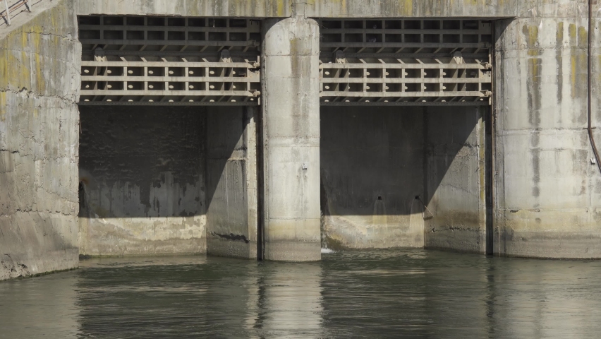 A river dam in early spring in a sunny day, an Industrial Video by Slatan