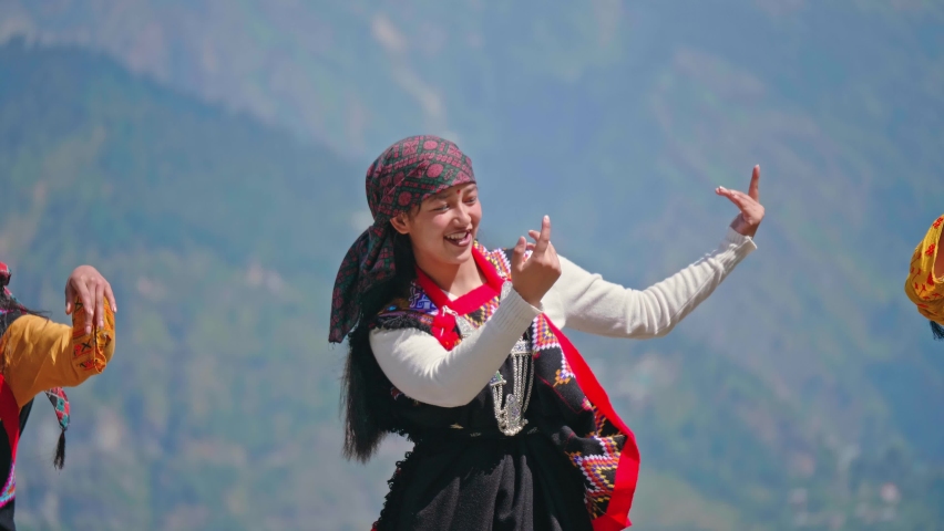 Young beautiful cheerful Indian Asian Woman or female wearing traditional attire dancing outdoors with a background of Mountainous valley in daylight. Concept of customs, music, culture, traditions | Shutterstock HD Video #1087686170