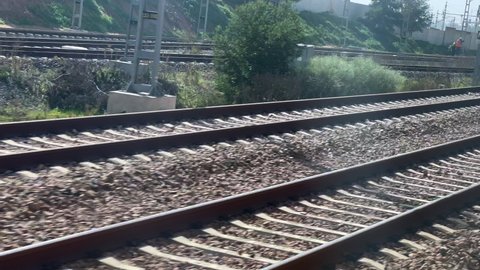 Motion-blur footage from a moving train over the railway tracks