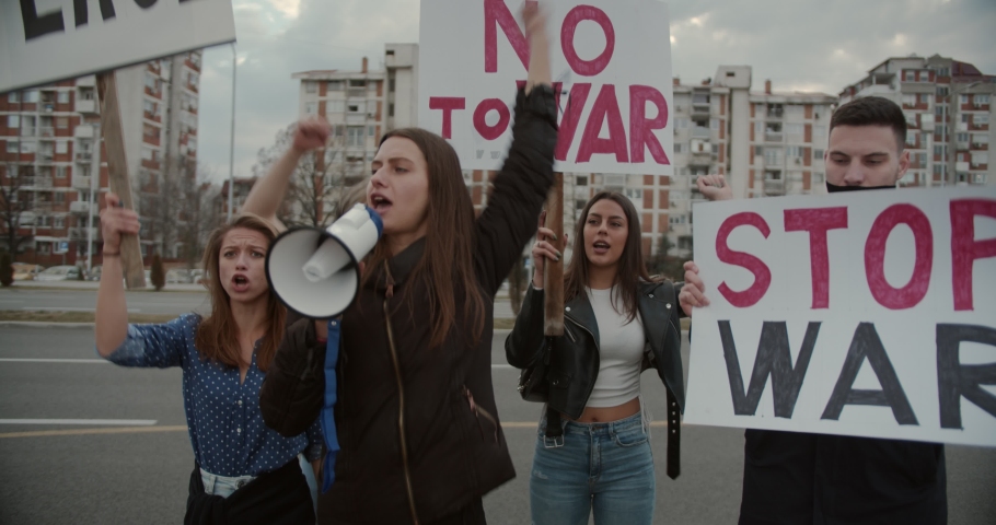 Peace rally, protestors giving support to the peace and to end the war in Ukraine. Anti war movement | Shutterstock HD Video #1087691060
