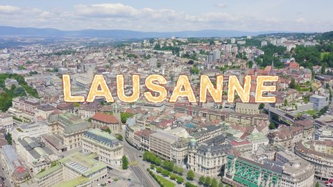 Inscription on video. Lausanne, Switzerland. Flight over the central part of the city. La Cite is a district historical centre. Heat burns text, Aerial View, Departure of the camera