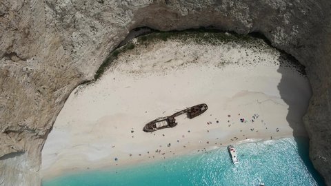 Dreamlike bird's eye view of world's most famous beach in Navagio, Zakynthos, Greece. Turquoise sea water and white sand beach with shipwrecked fishing vessel Panagiotis