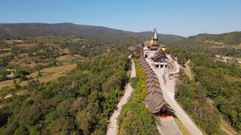 Aerial footage towards the temple as the drone moves over the complex, Wat Somdet Phu Ruea, Ming Mueang, Loei in Thailand.