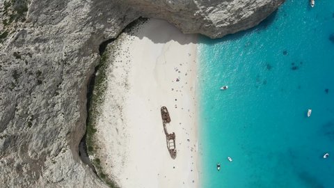 Aerial top-down view of the Navagio shipwreck beach in the Mediterranean island of Greece. Paradise seascape with white sand and blue turquoise water of Ionian sea