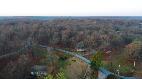 Trees With Leafless Branches In A Remote Middle of Nowhere Town Near Midwest Countryside Forest. Aerial Drone Searching Motion