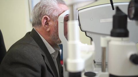 examination of the elderly man on the corneal topographer. Videokeratograph is medical device for determining curvature of cornea. mandatory device for modern clinic or opticians shop.