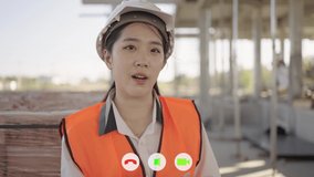 Close-up of a construction engineer wearing a white helmet at a construction site discussing problems and work progress. Looking at the camera. Video conference.