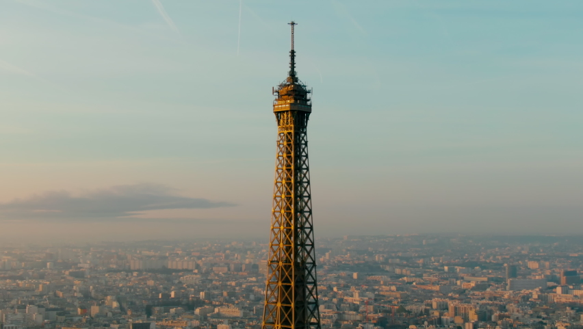 Aerial view Eiffel Tower as main Landmark Monument of Paris Cityscape. Capital of France Skyline. Famous European Touristic Destination. Travel and Urban Concept. 4K drone close up orbit shot