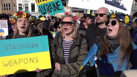 AMSTERDAM, NETHERLANDS – FEBRUARY 27 2022: Women wearing traditional Ukrainian headdress chant 'stop Putin, stop war', during protest against Russian invasion of the Ukraine. 