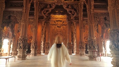 Pattaya, Thailand, February 2022 : Sanctuary of Truth (Prasat Sut Ja-Tum), Rear view of woman 
tourist at beautiful Thai wooden temple interior in Pattaya Thailand, Amazing Thailand travel concept.
