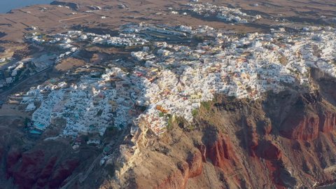 Aerial shot of famous Oia village in Santorini at sunrise in Greece. Greece, Europe. Luxury travel. Summer holidays.
