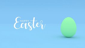 Green painted rolling egg on a blue background. Happy Easter, traditional spring holiday creative concept