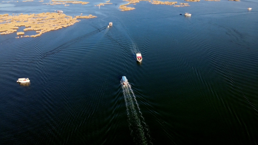 A shining summer sun and people sunbathing on the beach while enjoying the boat at Muğla Iztuzu Beach, one of Turkey
