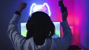 Young gamer playing strategy video game celebrating victory - Technology e-sport concept