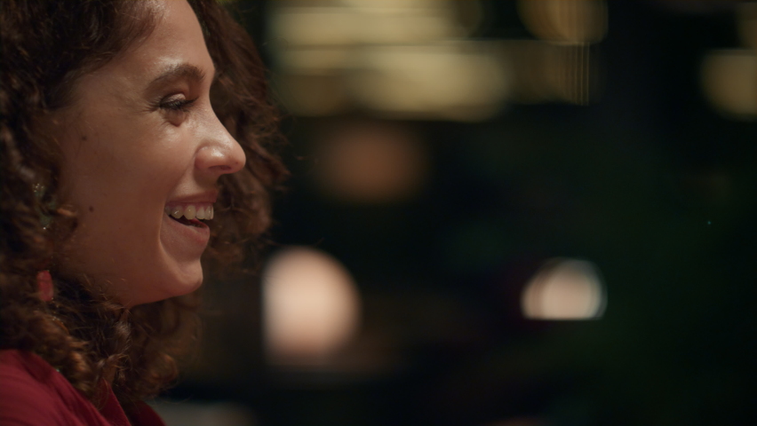 Beautiful woman drinking wine glass in fine dining restaurant. Portrait of attractive lady flirting smiling on date. African american female person laughing in cafe bar. Dinner enjoyment concept.