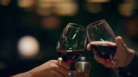Fancy couple clinking wine glasses in romantic light restaurant bar. Two people celebrate anniversary together in cafe close up. Unknown lovers enjoy alcohol drinks in luxury pub. Dinner date concept. วิดีโอสต็อก