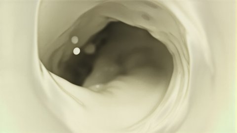 A whirlpool of fresh milk. Top view. Macro background. Filmed on a high-speed camera at 1000 fps. High quality FullHD footage
