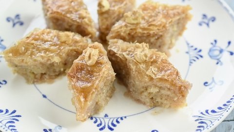 Eating of delicious baklava with walnuts.